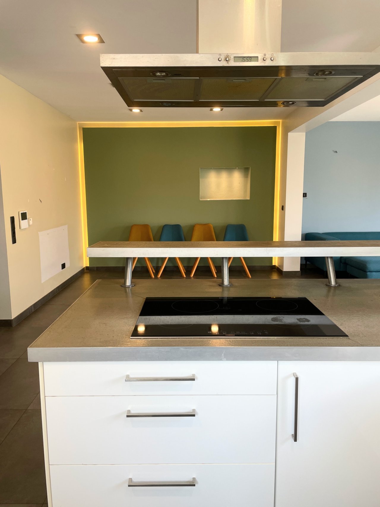 Moderne Kochinsellösung mit integriertem Essbereich und stimmungsvoller Lichtgestaltung Moderne Kochinsellösung mit integriertem Essbereich und stimmungsvoller Lichtgestaltung